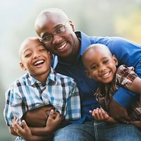 Father smiling with children